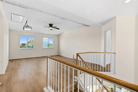 a view of staircase with wooden floor and a window