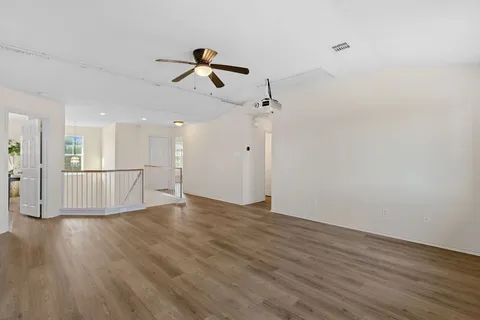 a view of a livingroom with wooden floor and white walls