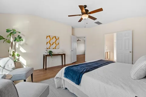 a bedroom with a bed couch and window