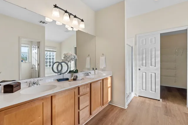 a spacious bathroom with a double vanity sink and a mirror