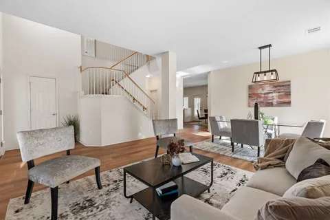 a living room with furniture and wooden floor