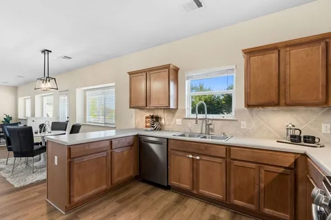 a kitchen with sink cabinets and window