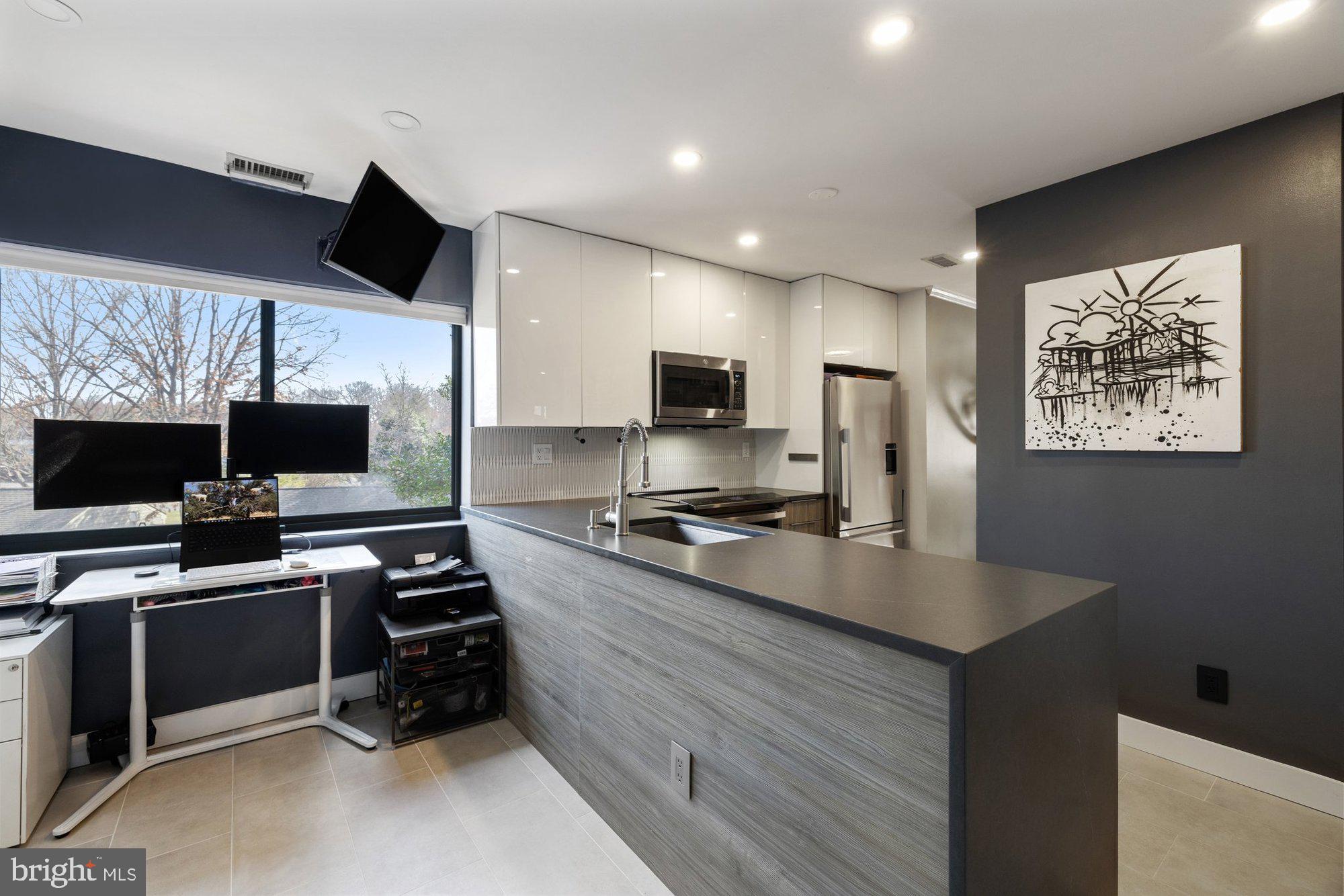 11120 Harbor Court, Unit 1120 Reston, VA 20191 - Photo 15 of 55 a kitchen with stainless steel appliances a stove microwave and refrigerator