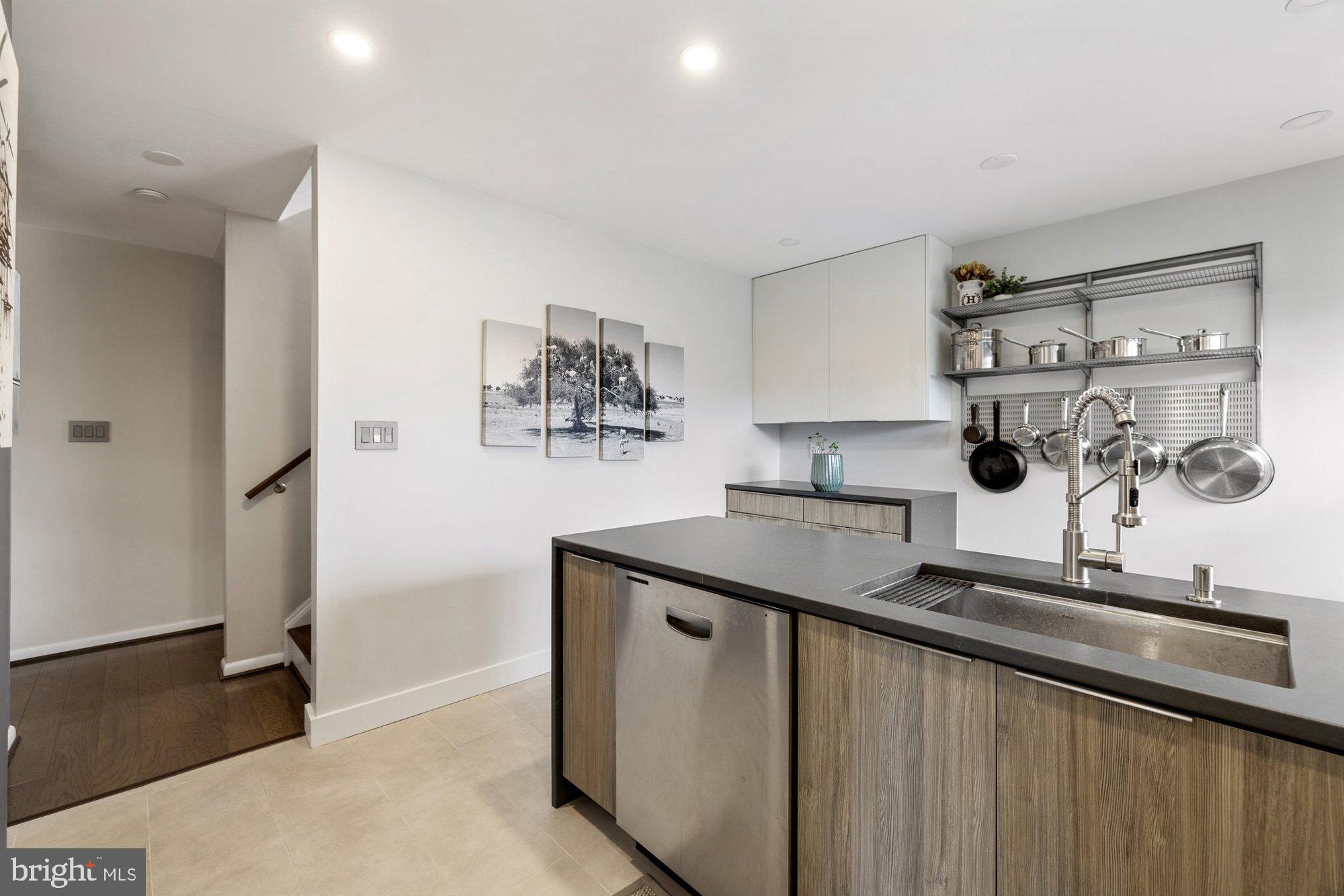 11120 Harbor Court, Unit 1120 Reston, VA 20191 - Photo 16 of 55 a kitchen with stainless steel appliances granite countertop a sink and a stove with white countertops