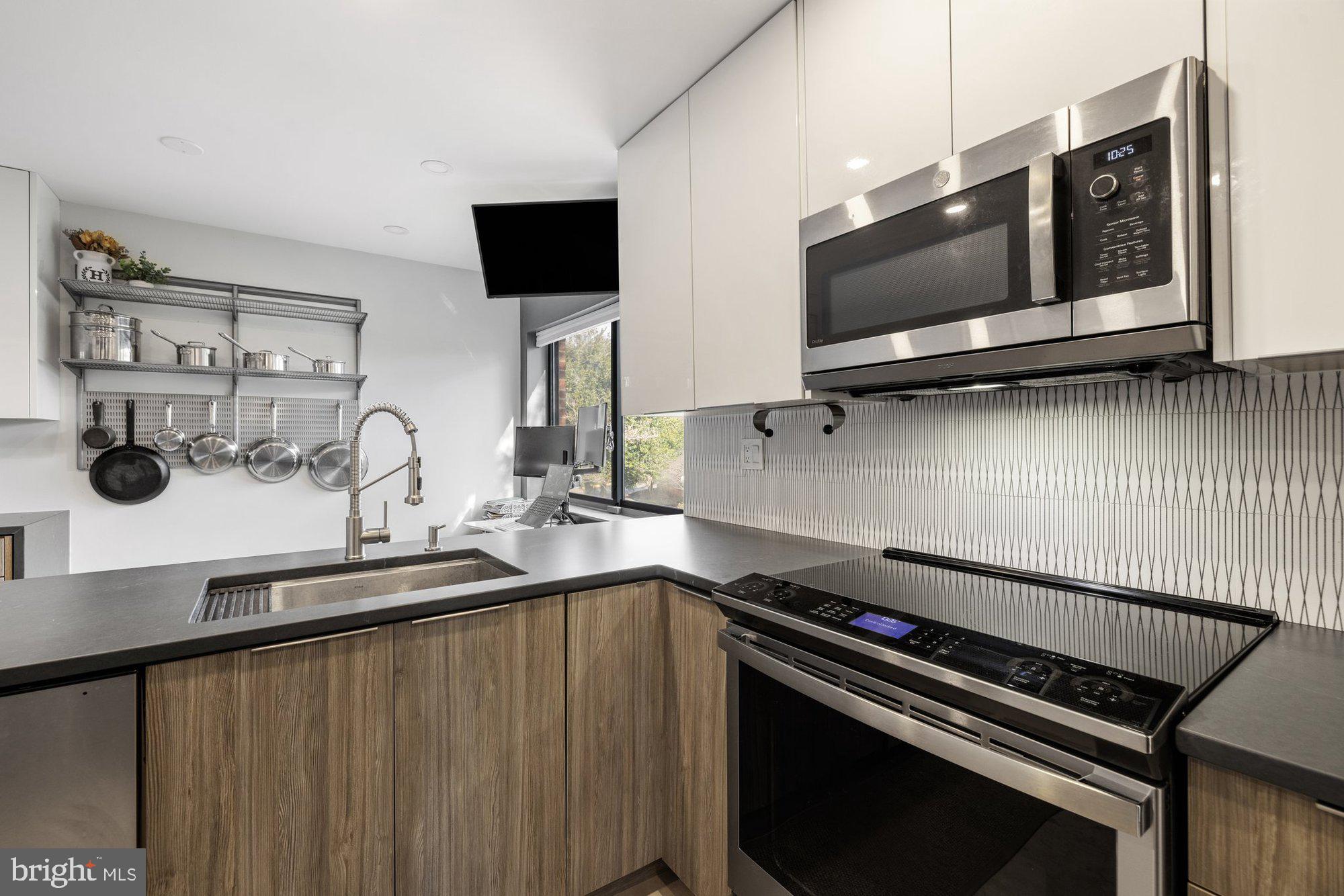 11120 Harbor Court, Unit 1120 Reston, VA 20191 - Photo 17 of 55 a kitchen with a sink and a stove top oven