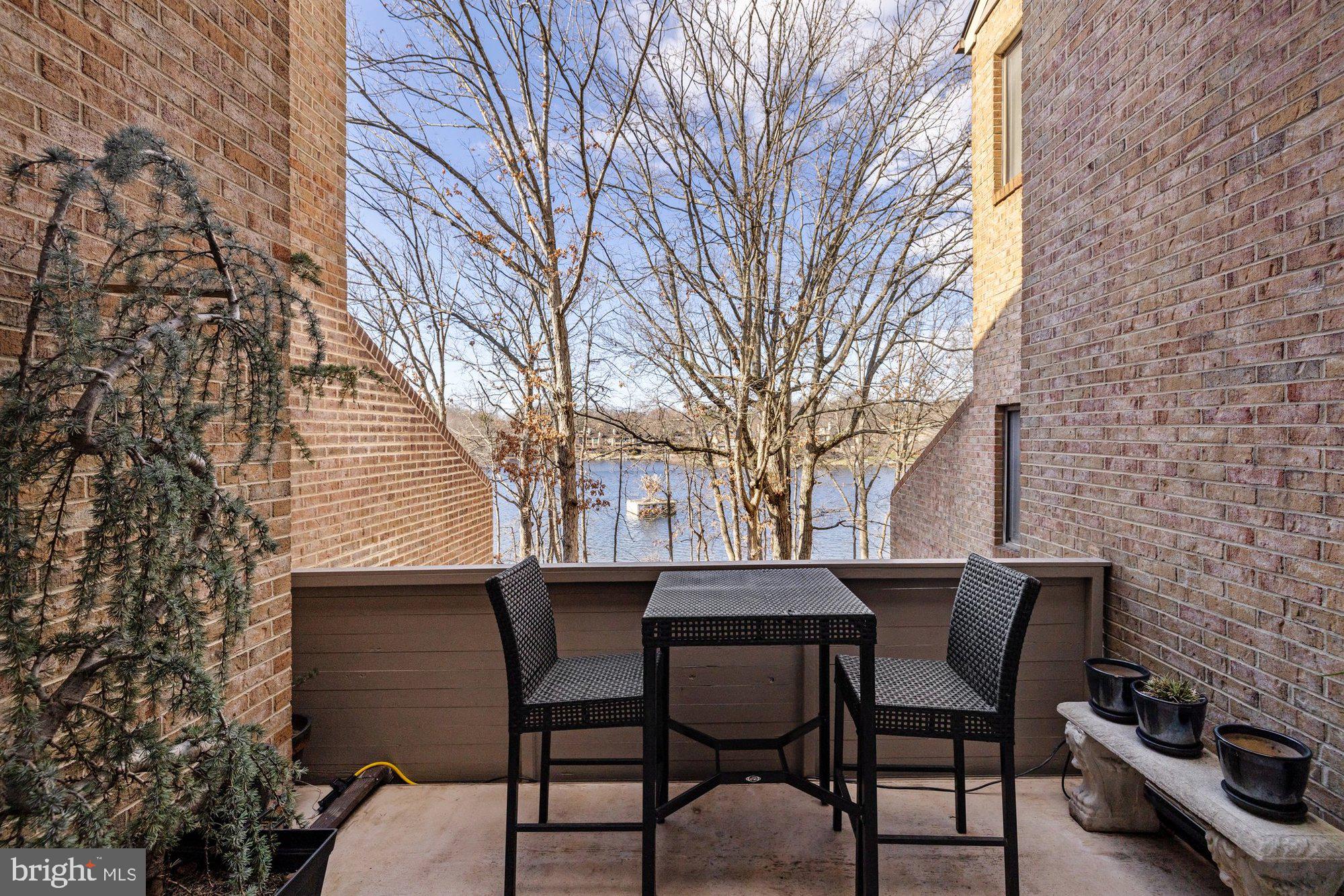 11120 Harbor Court, Unit 1120 Reston, VA 20191 - Photo 23 of 55 a backyard of a house with table and chairs