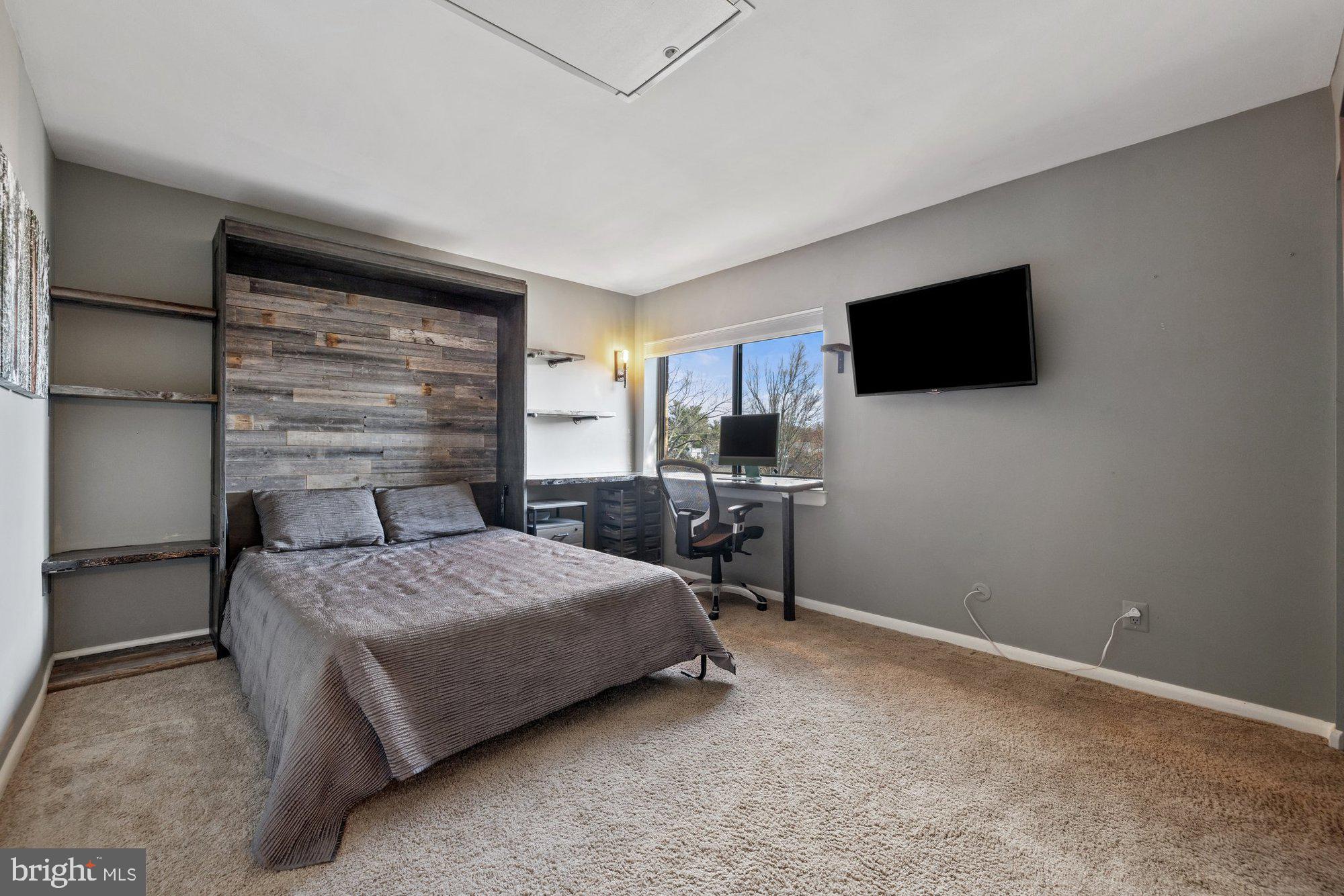 11120 Harbor Court, Unit 1120 Reston, VA 20191 - Photo 33 of 55 a bedroom with a bed a flat screen tv and a window