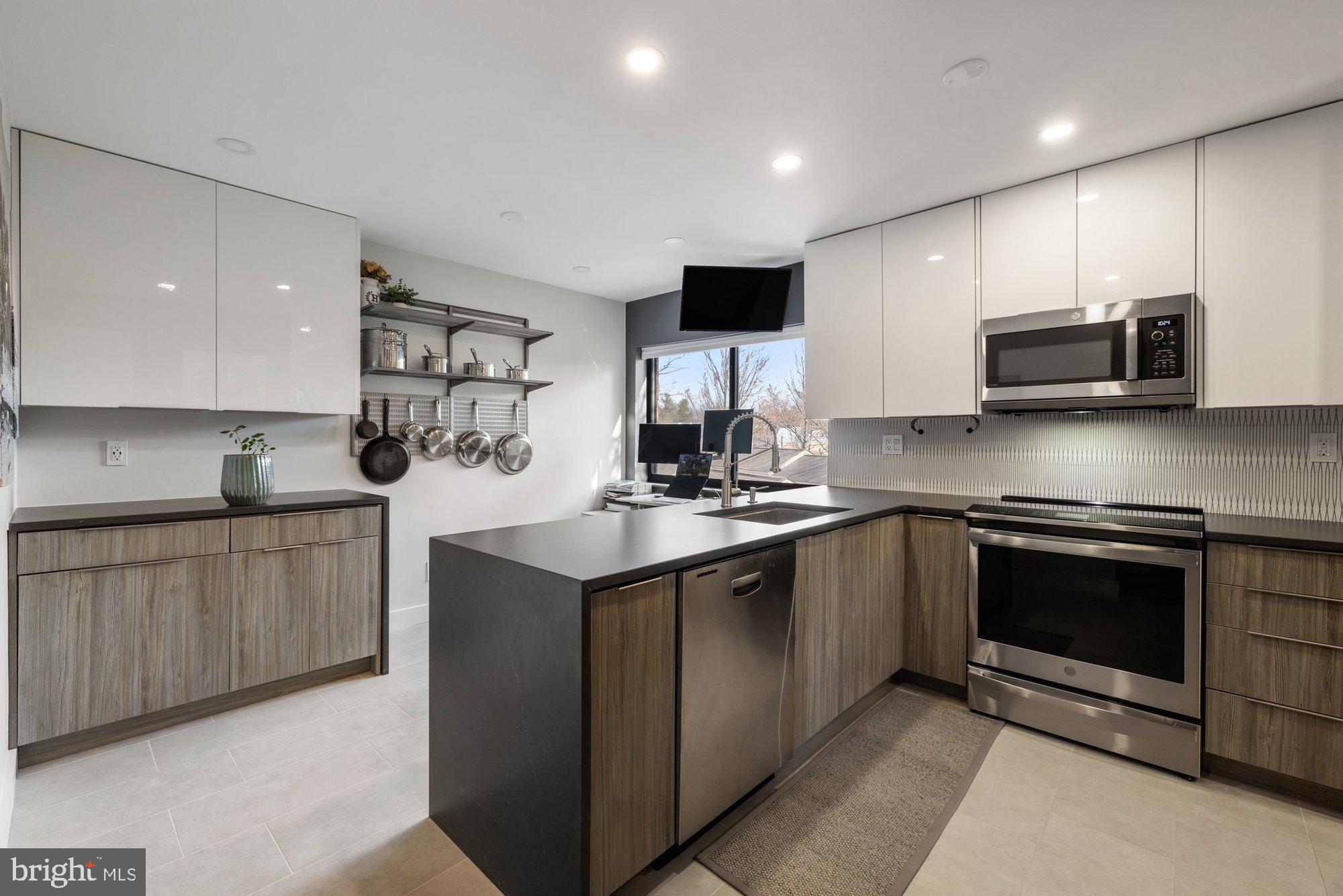 11120 Harbor Court, Unit 1120 Reston, VA 20191 - Photo 5 of 55 a kitchen with stainless steel appliances granite countertop a sink and stove top oven