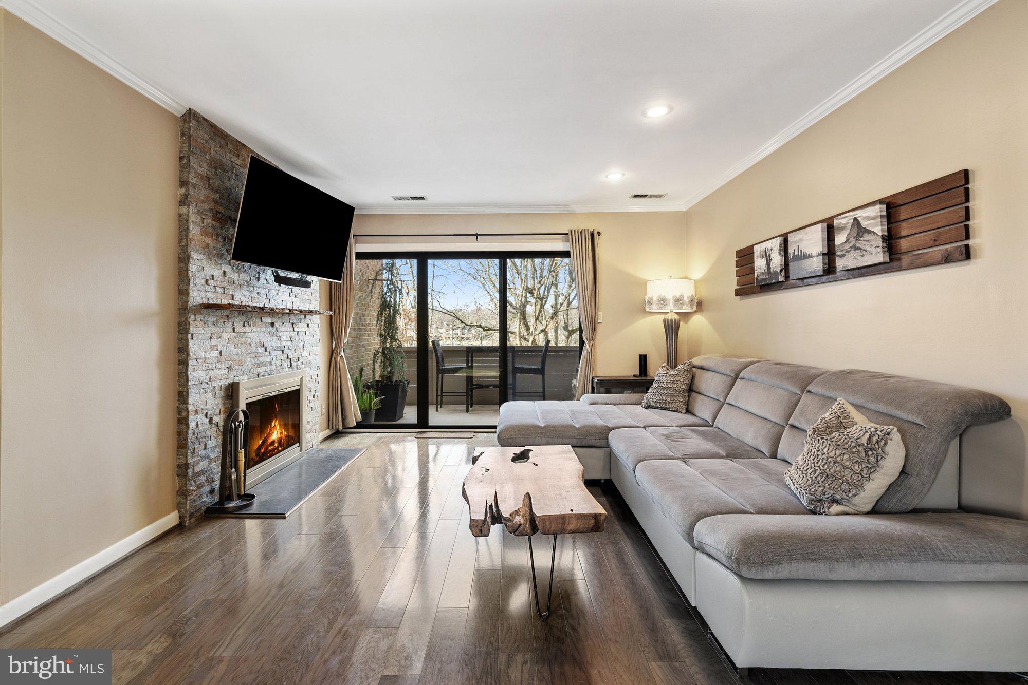 11120 Harbor Court, Unit 1120 Reston, VA 20191 - Photo 6 of 55 a living room with furniture fireplace and flat screen tv