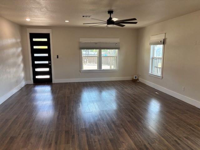 4707 Chapman Street Fort Worth, TX 76105 - Photo 2 of 21 a view of wooden floor and windows in a room
