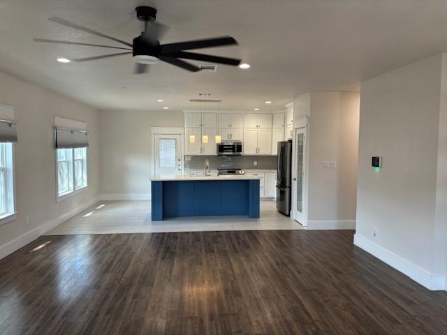 4707 Chapman Street Fort Worth, TX 76105 - Photo 4 of 21 a large kitchen with stainless steel appliances granite countertop a refrigerator a stove and a wooden floors