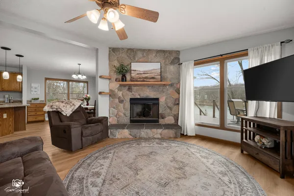 a living room with furniture a flat screen tv and a fireplace