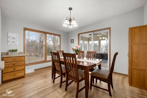 a view of a dining room with furniture window and wooden floor