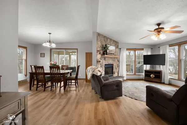 a living room with furniture a fireplace and a flat screen tv