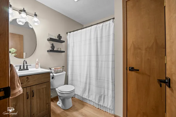 a bathroom with a toilet a sink and a mirror
