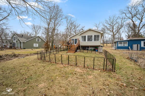 a front view of a house with a yard covered with snow