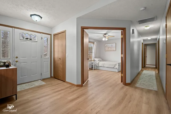 a view of a room with wooden floor and bathroom