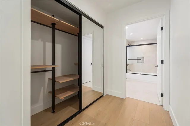 a view of walk in closet with empty racks