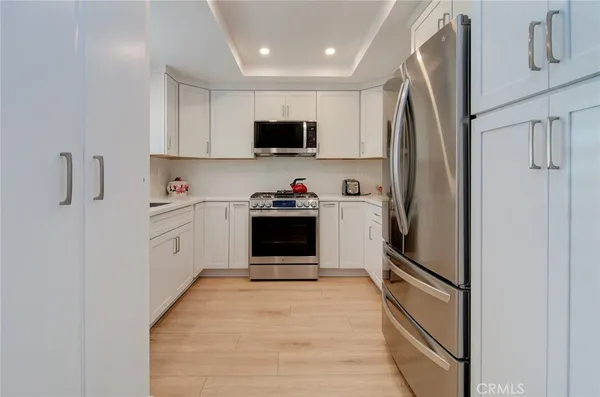 a kitchen with stainless steel appliances a stove a microwave and sink