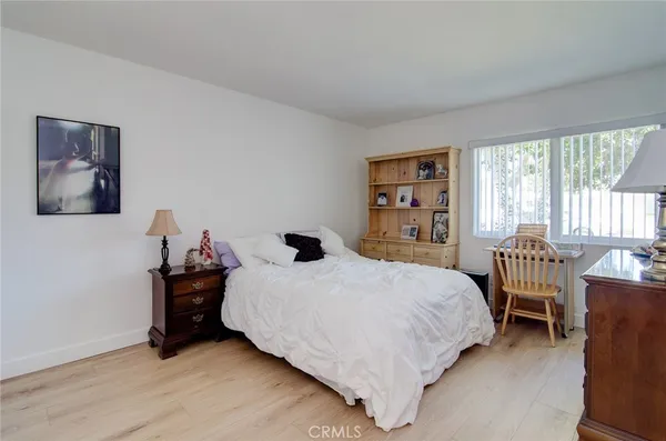 a bedroom with a bed and a night stand