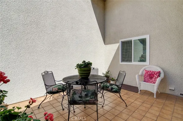 a view of a house with backyard and sitting area