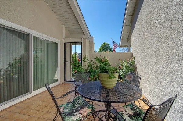 a view of a chairs and table in a backyard