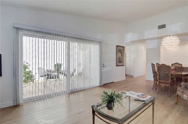 a dining room with furniture and wooden floor