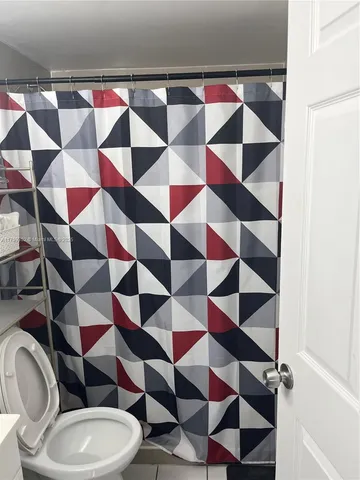 a bathroom with a toilet and shower