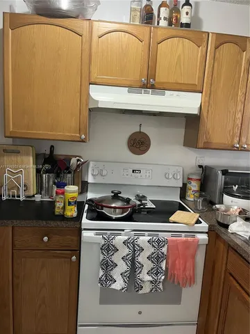 a kitchen with a stove and cabinets