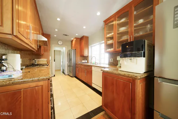 a kitchen with stainless steel appliances granite countertop a stove and a refrigerator