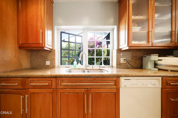 a kitchen with granite countertop cabinets and window