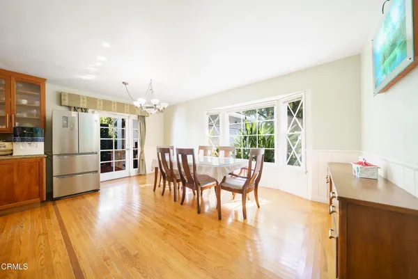 a dining room with furniture and wooden floor
