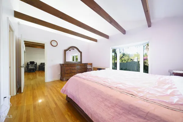 a spacious bedroom with a bed and a view of bathroom
