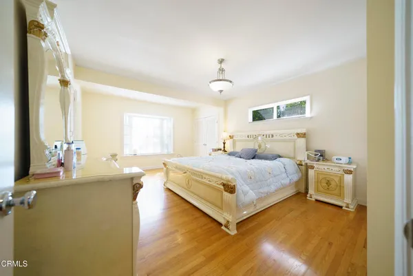 a bedroom with a bed and a chandelier