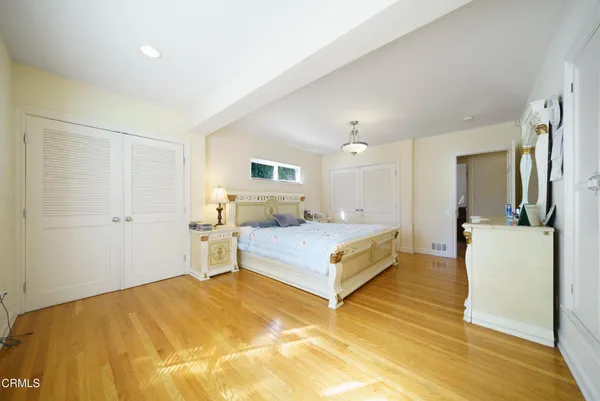 a spacious bedroom with a bed and a couch