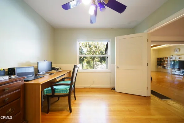 a view of a workspace with furniture and a window