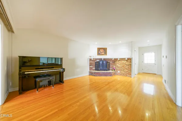 a spacious bedroom with a bed and dresser