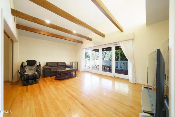 a living room with furniture window and wooden floor
