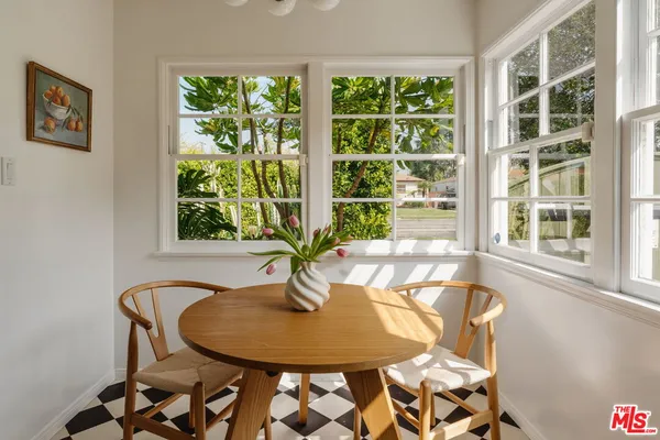 a dining room with a table and chairs