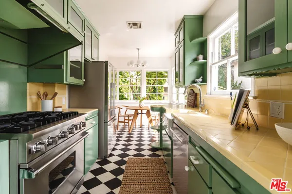 a kitchen with a stove a sink and a cabinets