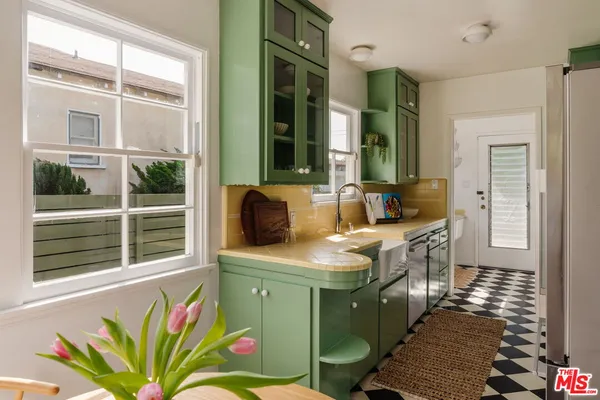 a kitchen with a sink a counter top space and a window