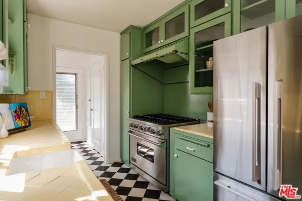 a kitchen with a refrigerator and a stove