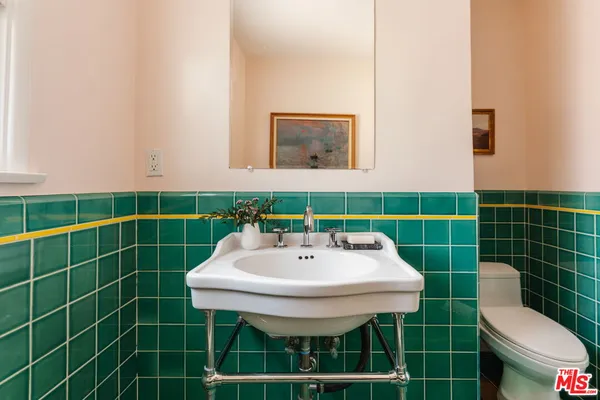 a bathroom with a sink mirror and toilet