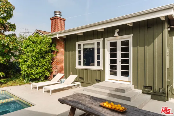 a view of a house with backyard and sitting area