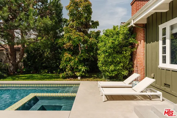 a view of swimming pool with seating space