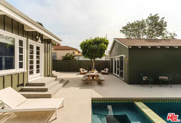 a view of a roof deck with couches and potted plants