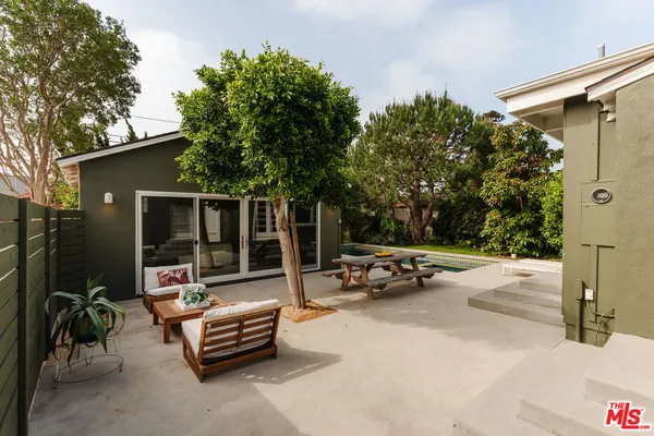 a view of a patio with a table and chairs