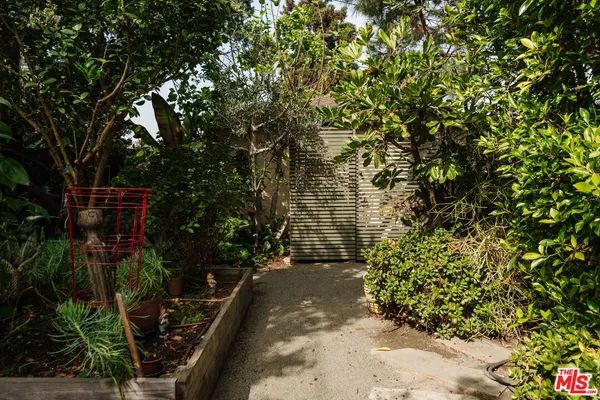 a view of house with swimming pool and a yard