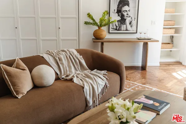 a bedroom with two beds and painting on the wall