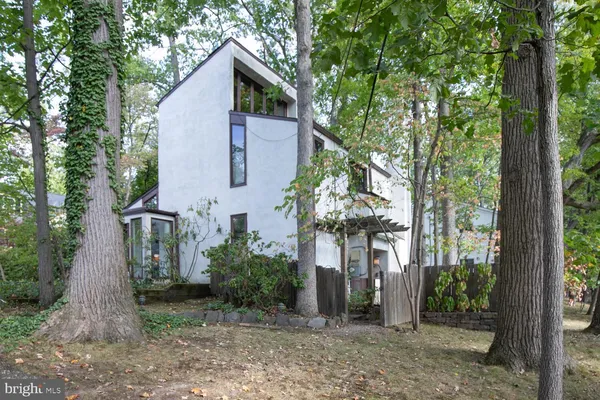 a view of a house with a tree in front